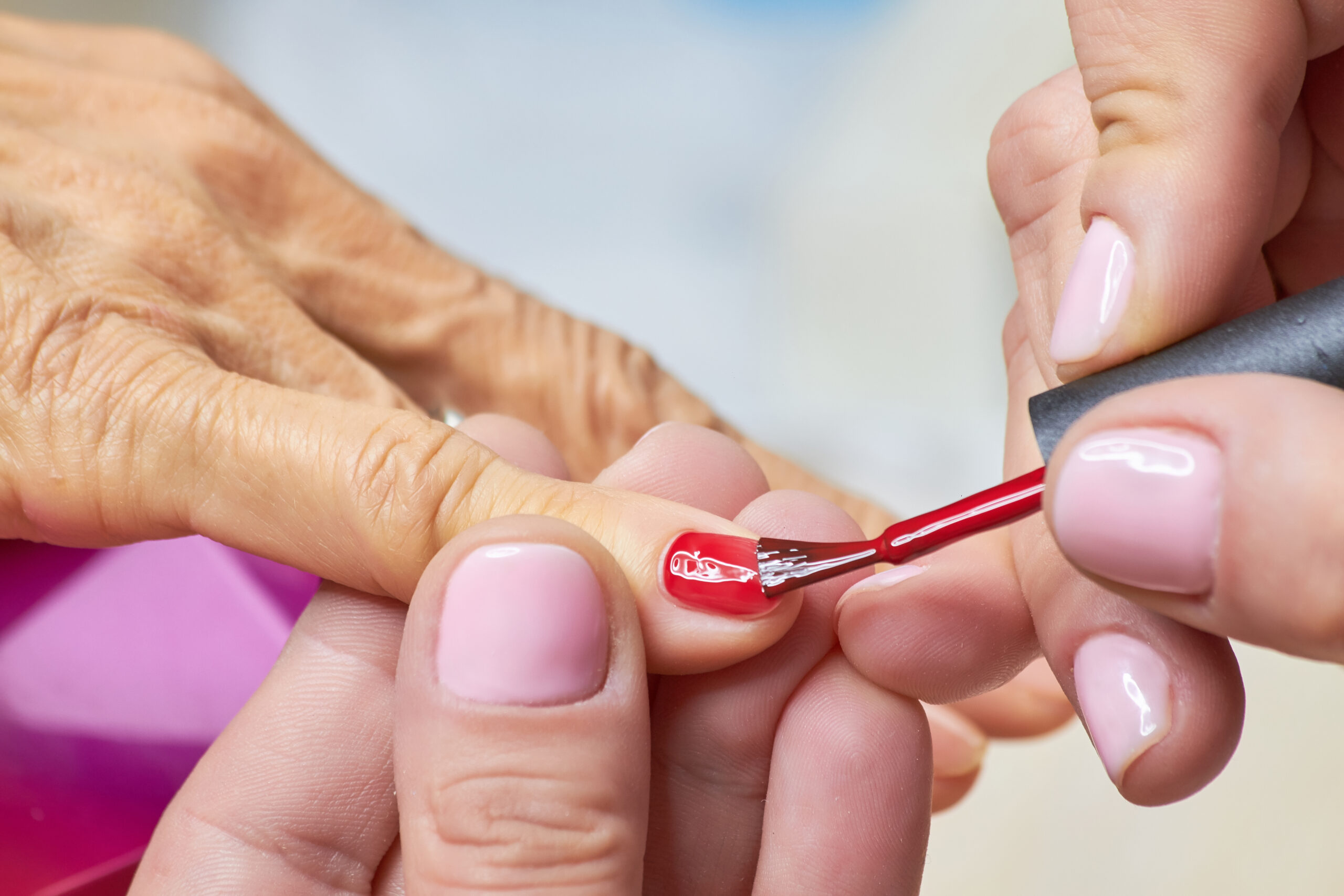 Manicurist,Applying,Red,Varnish,To,Senior,Woman.,Nails,Beautician,Painting