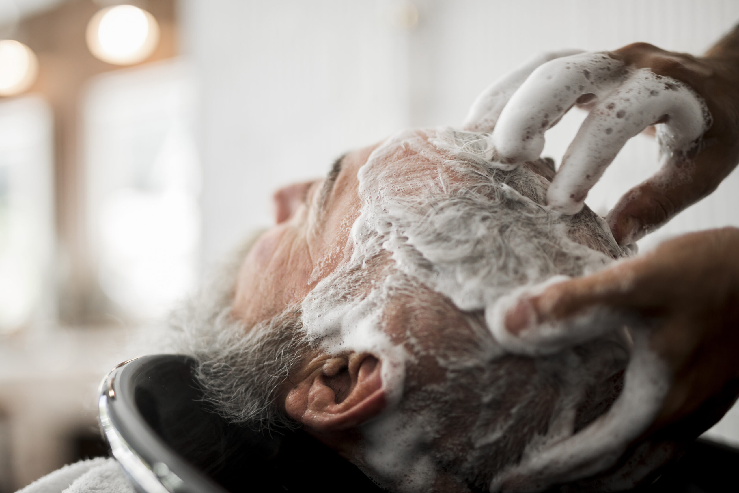 Washing,Hair,Of,Senior,Male,In,Barbershop